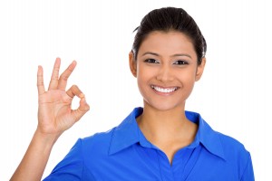 Closeup portrait of young  happy, smiling excited beautiful natural woman giving OK sign with fingers, isolated on white background. Positive emotion facial expressions symbols, feelings attitude